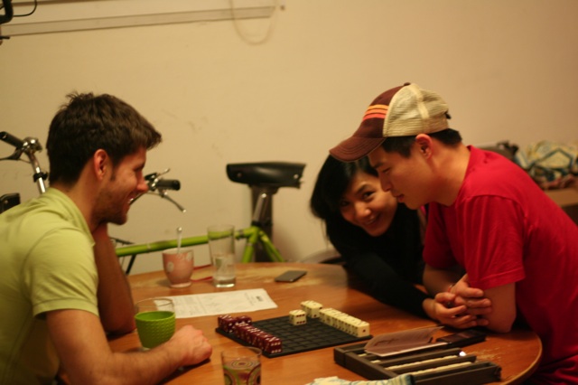 games L, Carmen and Sam playing boardgames after dinner.