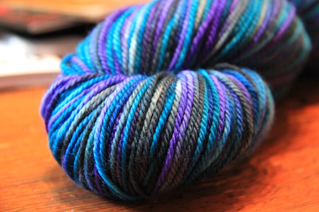 The parents aren't telling whether it's a boy or a girl, but I think this can go either way. (In case you're curious, it's Indigodragonfly DK Superwash in "Fringe Over Troubled Water")